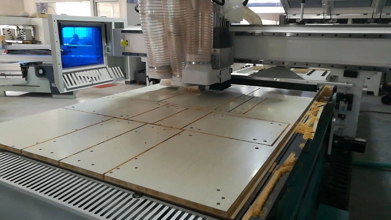 CNC router cutting a sheet of panel stock