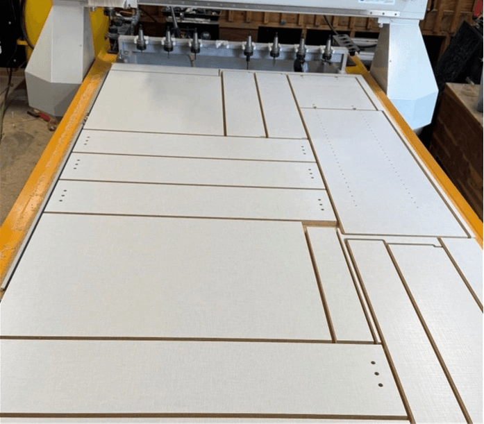 A full sheet of cabinet parts nested and cut on the router bed