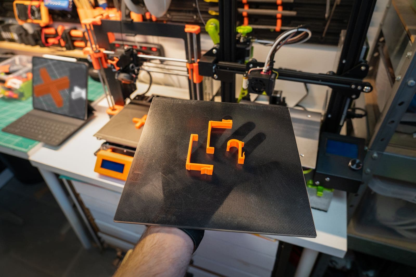 A build plate of freshly printed parts lifted off the printer